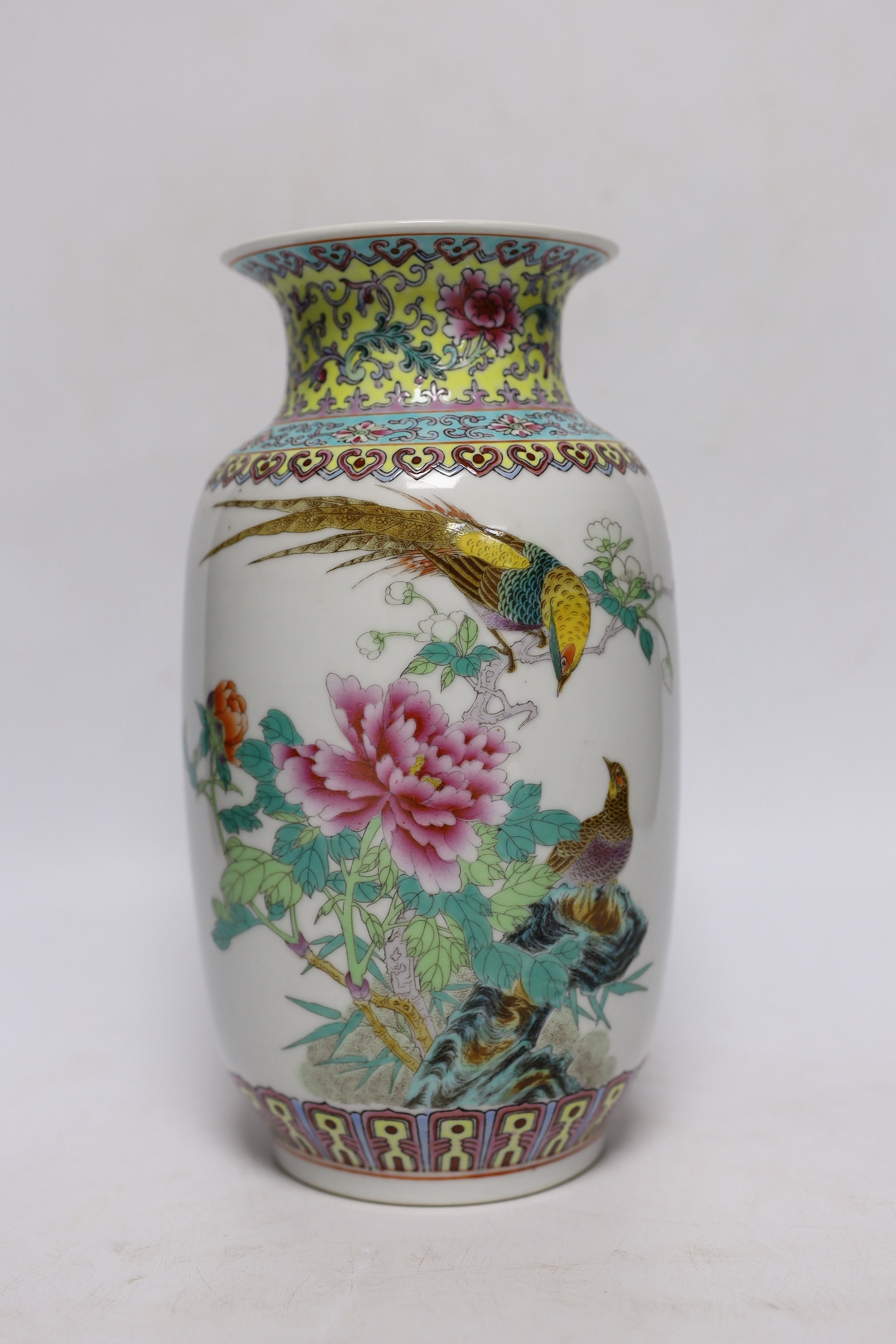 A Chinese famille rose vase, two Japanese blue and white rice bowls and covers and a Japanese blue and white vase (4) tallest 24.5cm